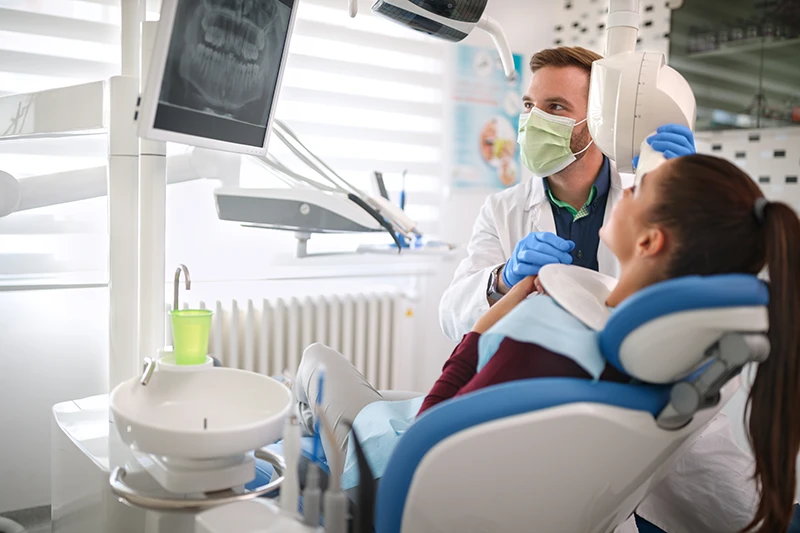 Dentist reviews a dental x-ray with a patient