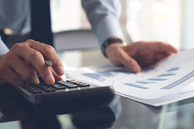 A doctor reviews data and calculates operating costs for his practice