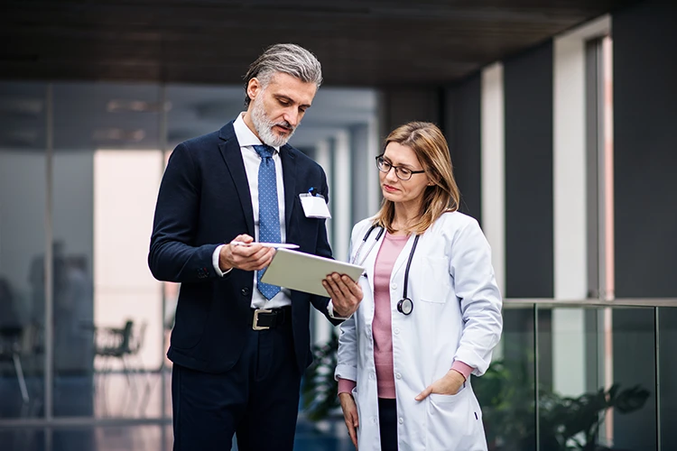 Medical practice broker reviews business valuation details with a physician