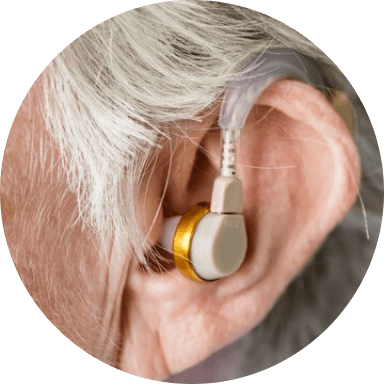 An audiology patient with a hearing aid in her ear