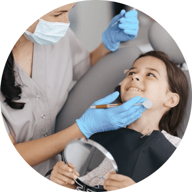 Dental hygienist cleaning a child's teeth